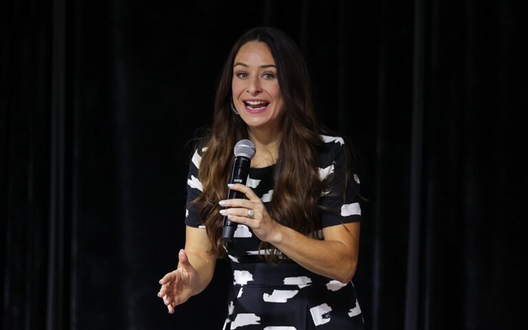 Emmie speaking on stage